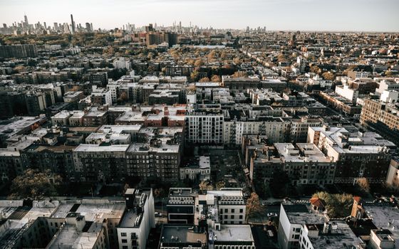 A breathtaking aerial view of Brooklyn with New York City skyline, shot during the day.