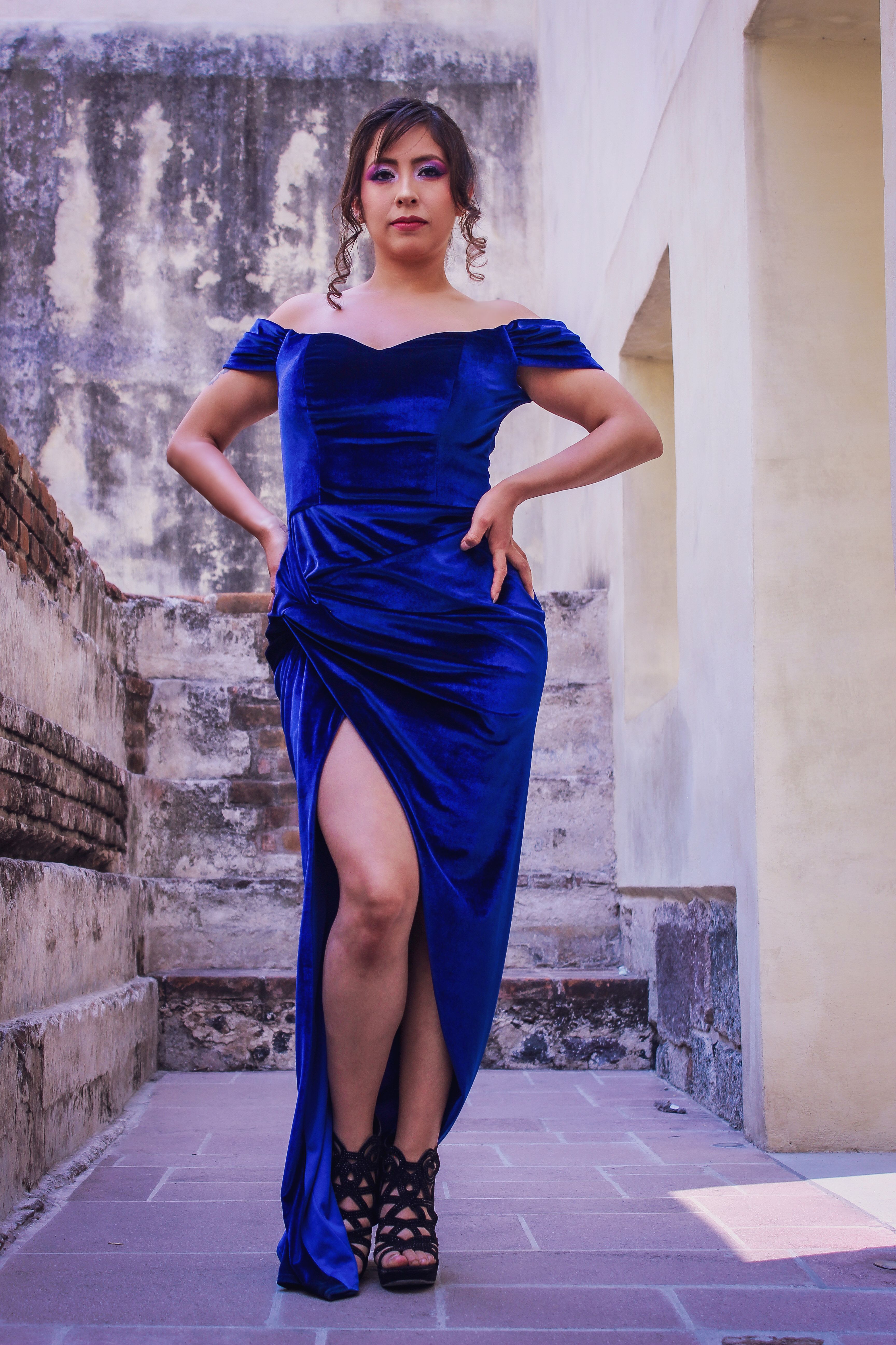 Elegant Latina Woman in Blue Dress on Balcony · Free Stock Photo