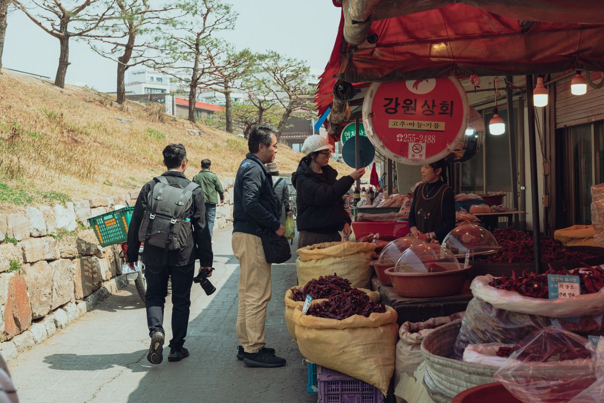 Explore a vibrant street market in Seoul with local vendors and colorful displays.