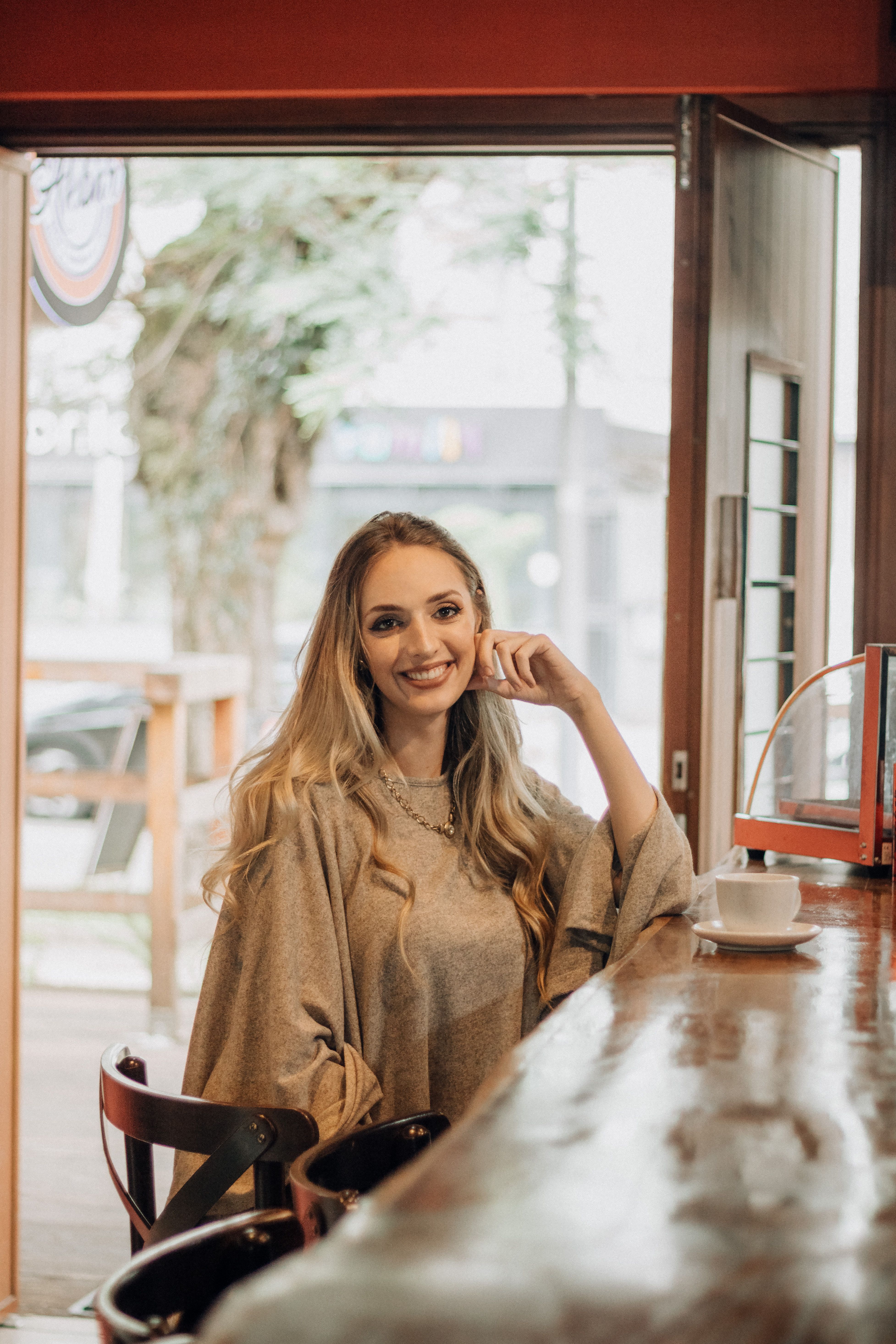 Smiling Woman Relaxing in Cozy Coffee Shop · Free Stock Photo