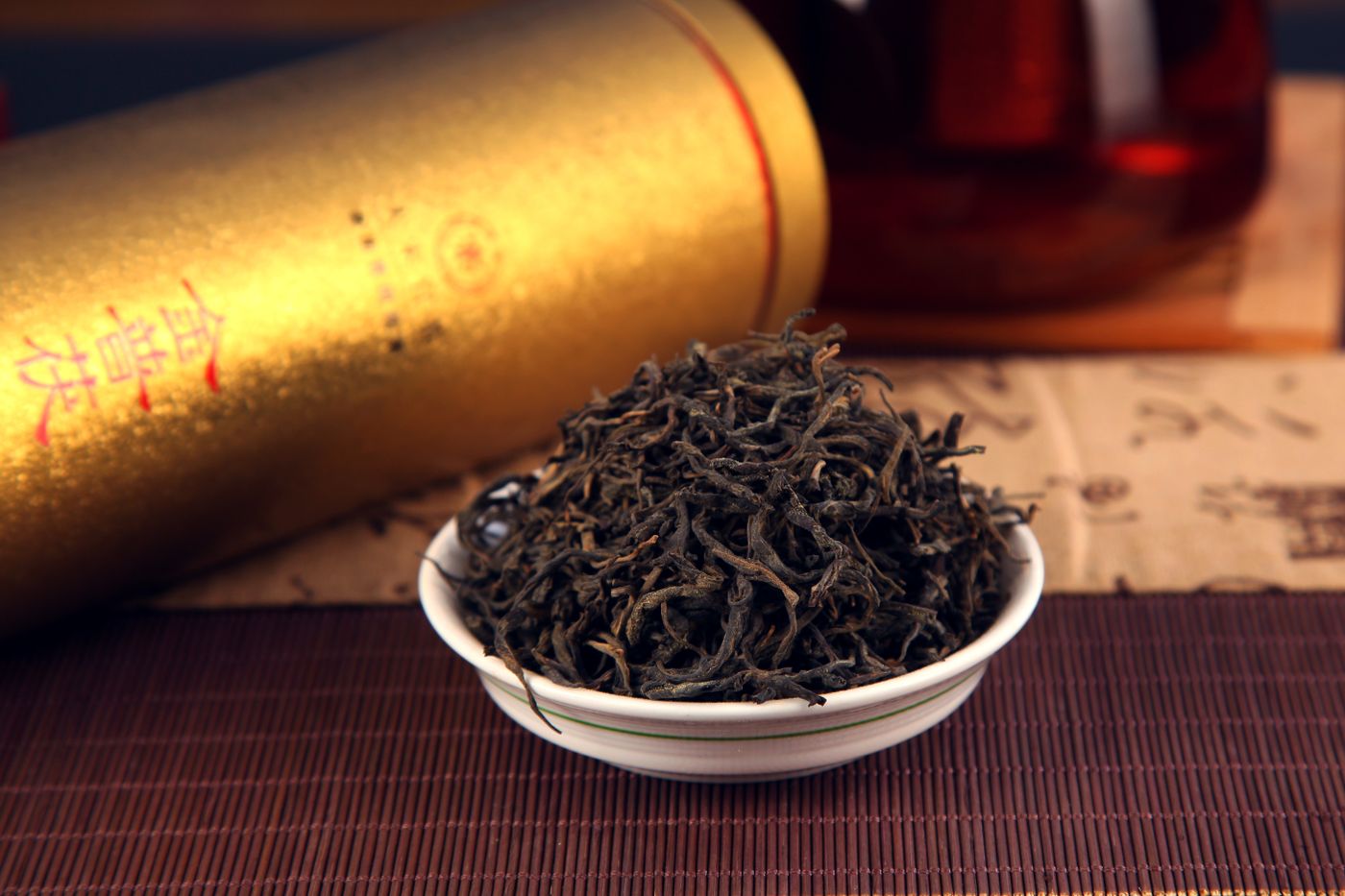 Premium black tea leaves displayed in a traditional tea setting.