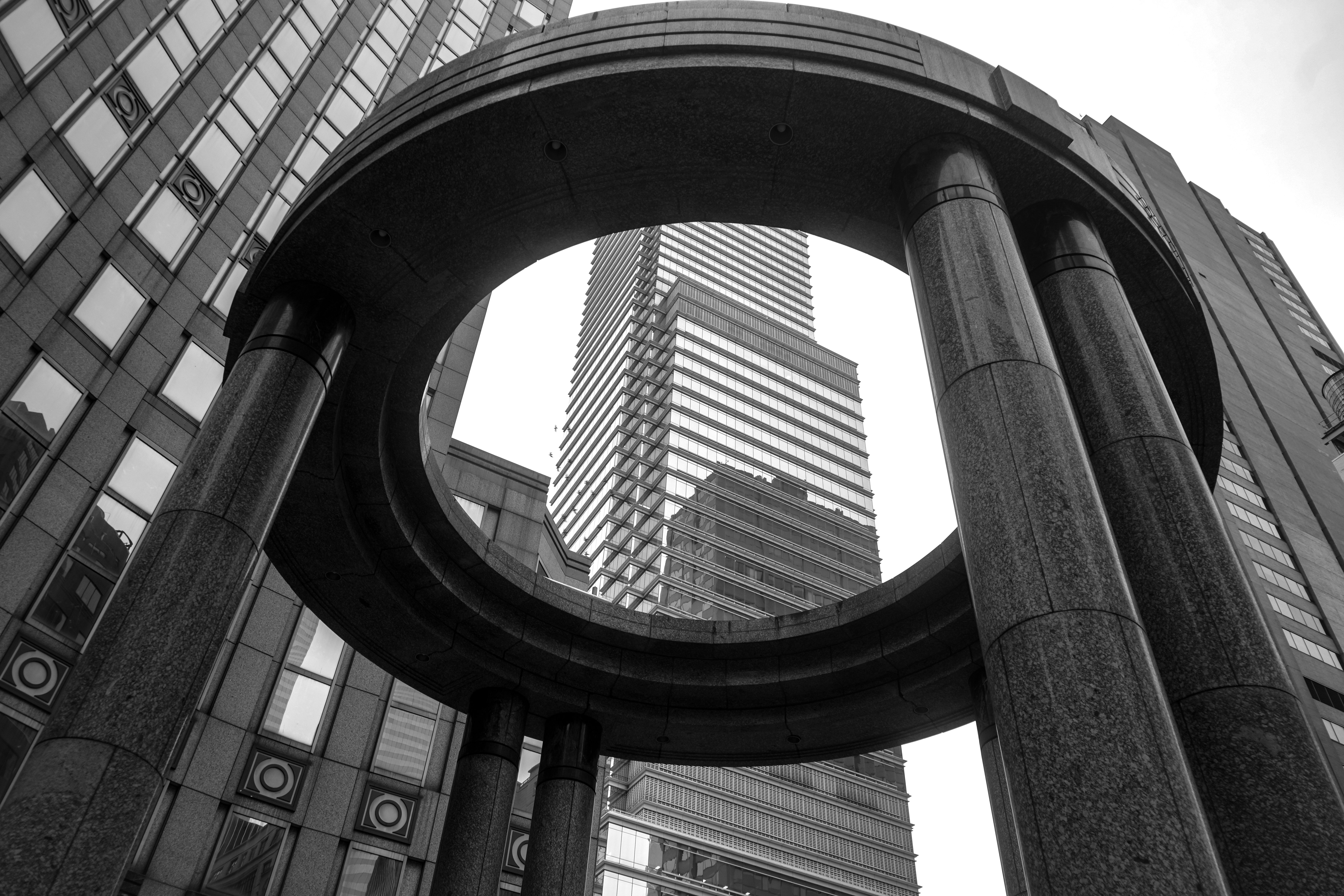 Dramatic black and white view of modern architecture in a metropolitan cityscape.