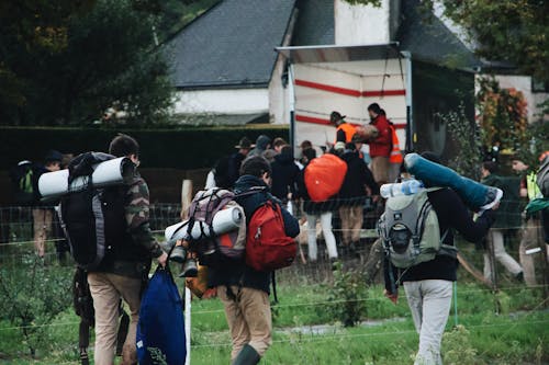 Photo Of People Bringing Backpack
