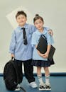 Adorable School Children in Uniform Posing Together