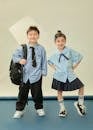Cute Kids in School Uniforms Posing Indoors