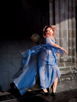Stunning woman in a flowing blue dress striking an elegant pose outdoors in Ciudad de México.