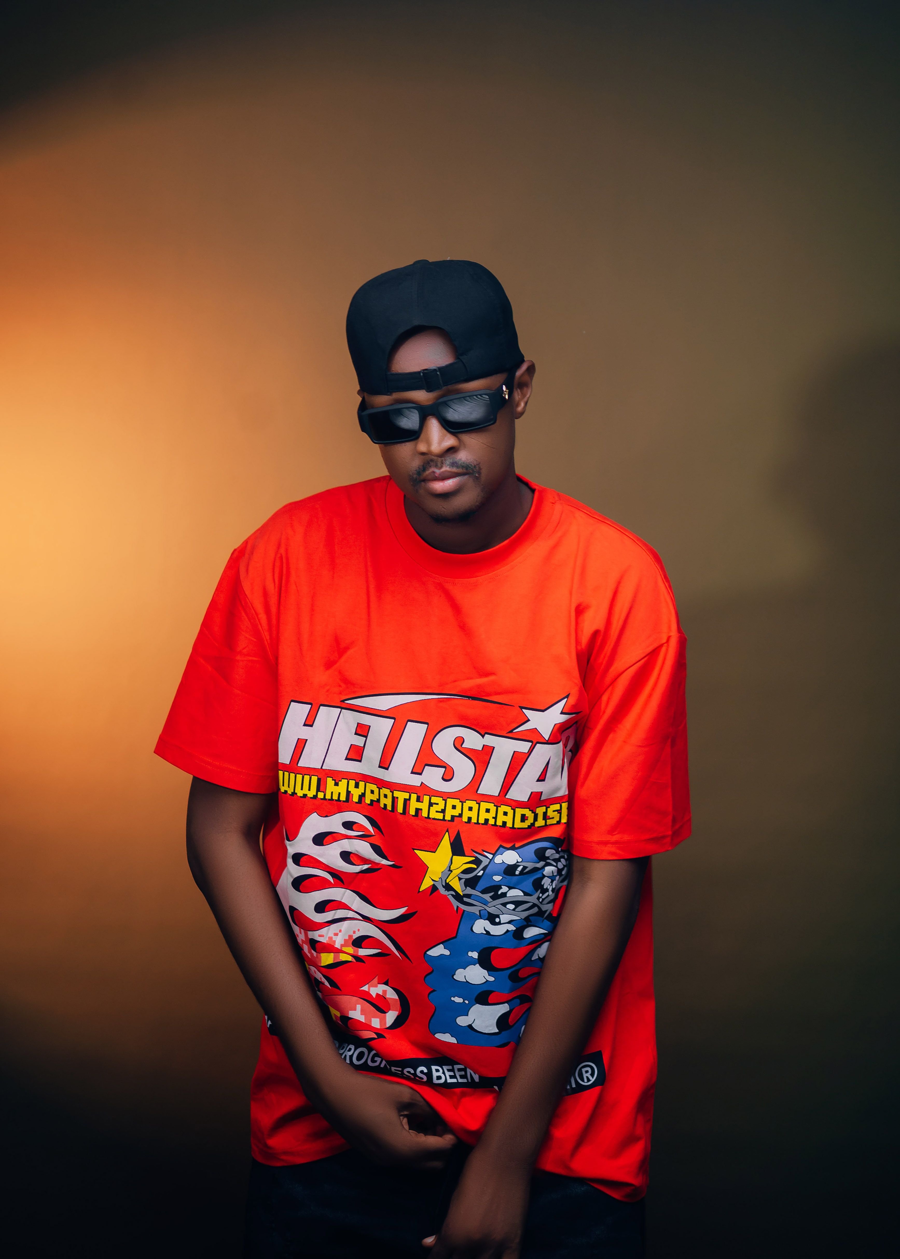 Portrait of a person in a bold graphic t-shirt and cap showcasing urban street style.