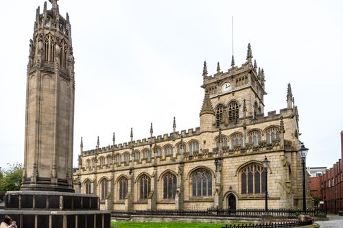 Free Stunning view of a historic church featuring Gothic architecture and clock tower. Stock Photo