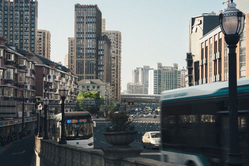 Free Dynamic city scene capturing buses and traffic amidst towering skyscrapers in daylight. Stock Photo