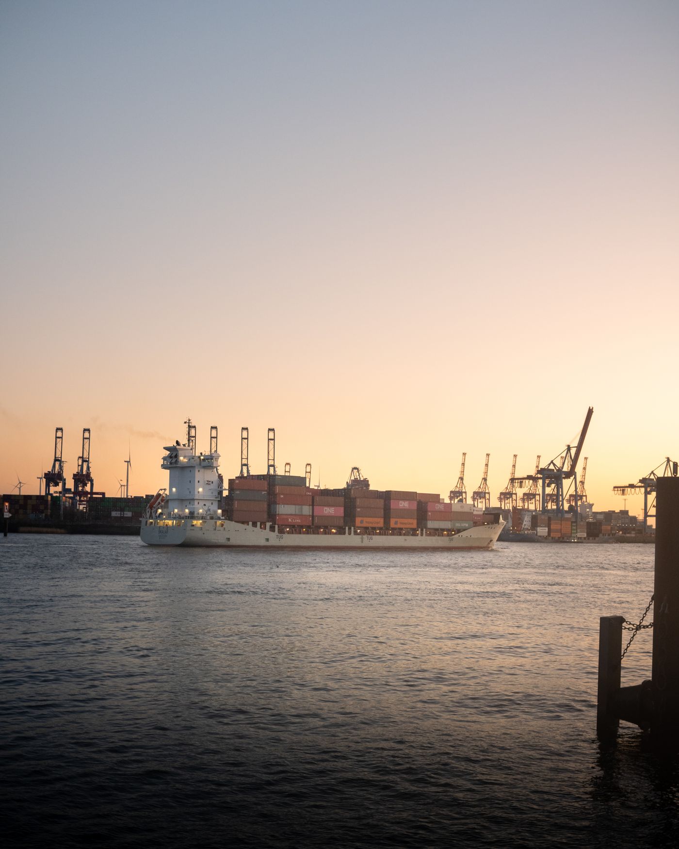 Container ship at a harbor at sunset