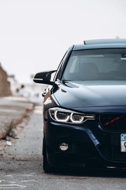 Free Front view of a modern black BMW car on a street in Cairo, Egypt, during the day. Stock Photo