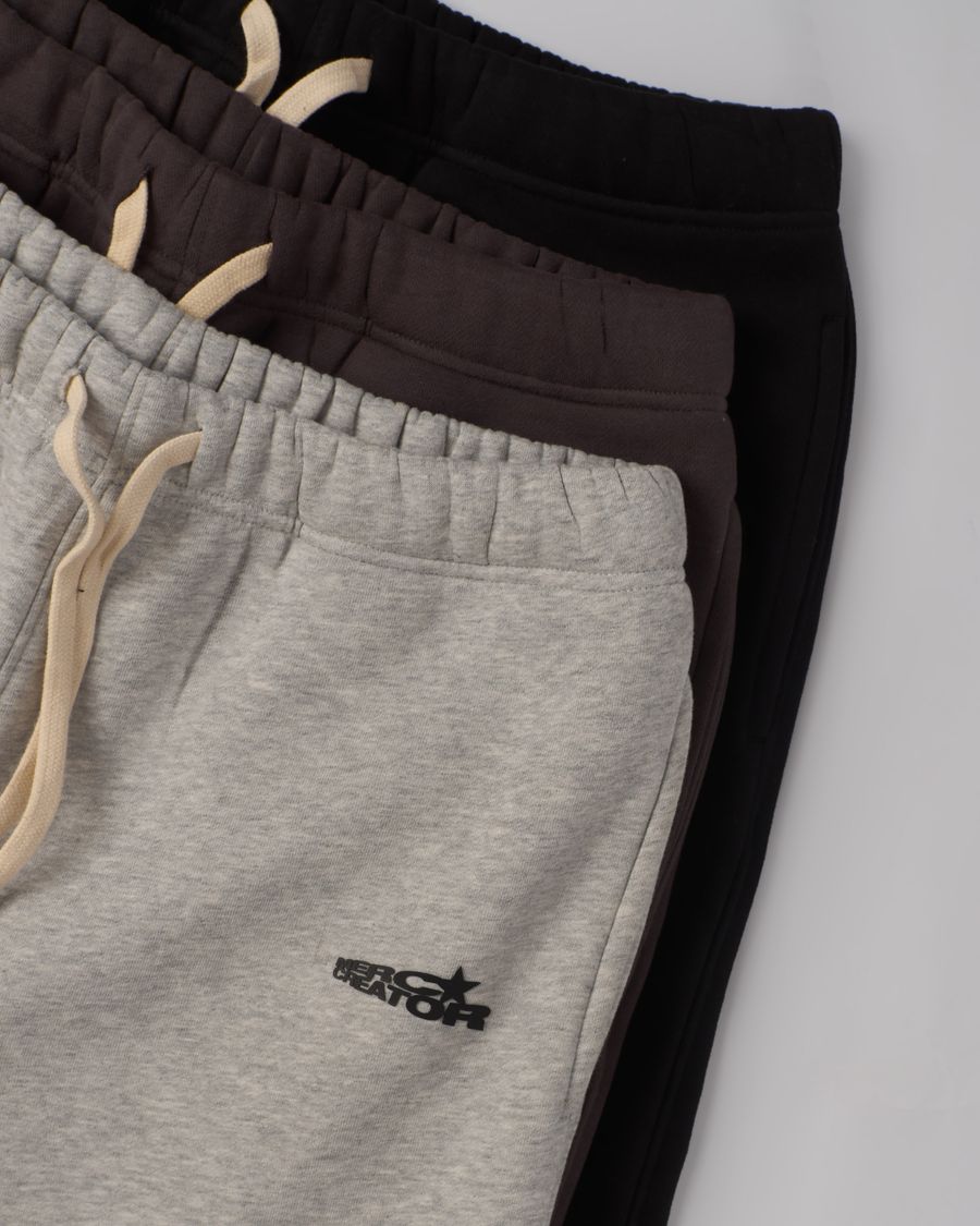 Folded everyday essentials in warm neutral tones, product flat lay