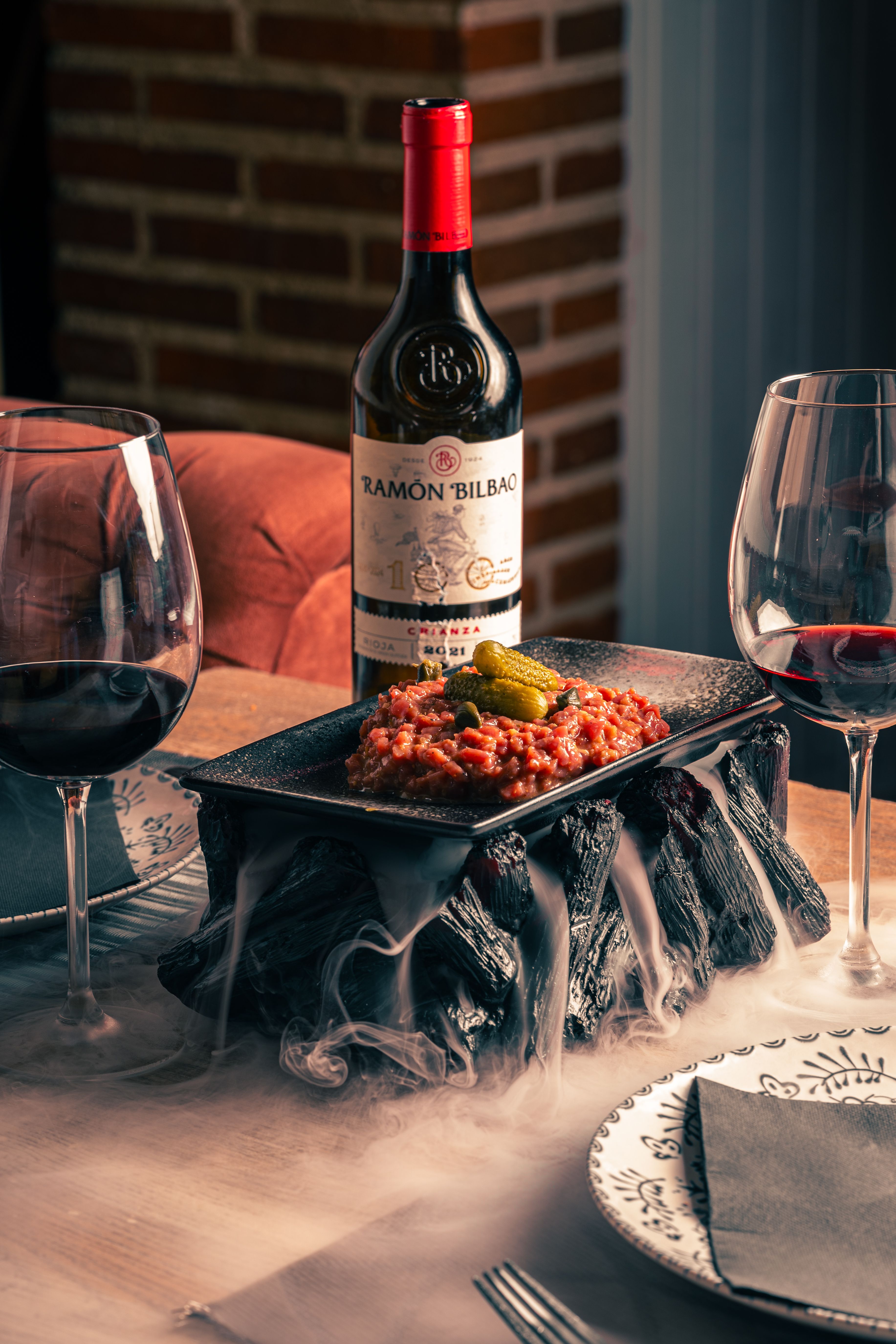 A sophisticated dining table with wine and appetizers, perfect for an intimate gathering.