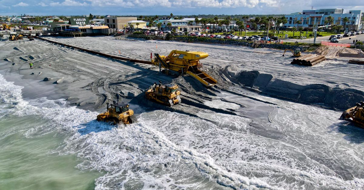 Aerial view of beach restoration with machinery at Flagler Beach, Florida.
