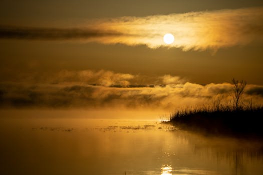 Beautiful sunrise over a mist-covered lake in Weaver, Minnesota. Tranquil and atmospheric scene.