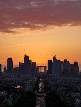 Capture of La Défense skyline with a vibrant orange sunset in Paris, France.