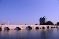 Stone Bridge over Seyhan River with Background Mosque