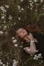 Woman Lying in Wildflower Meadow Relaxing