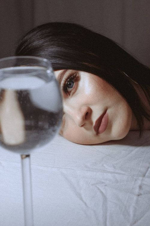 Free Moody portrait of a woman with reflective glass, artistic and introspective. Stock Photo