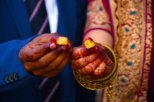 Free Close-up of an Indian couple exchanging golden rings during a traditional wedding ceremony. Stock Photo