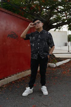 Portrait of a man posing outdoors in Merida, Yucatan, Mexico, wearing urban fashion.