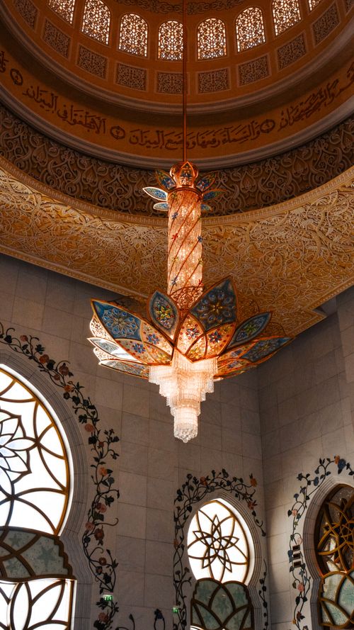 Free An ornate chandelier hanging under the decorated dome of a mosque in Abu Dhabi, United Arab Emirates. Stock Photo