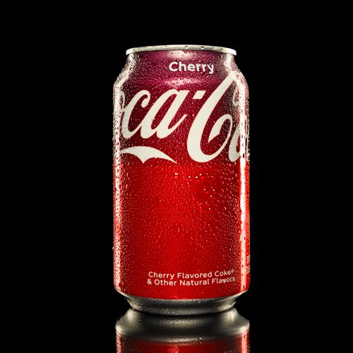 Free A close-up of a dew-covered Coca-Cola Cherry can isolated against a black background. Stock Photo