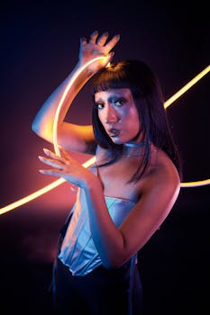 A woman poses with neon lights in a futuristic, artistic fashion setting.