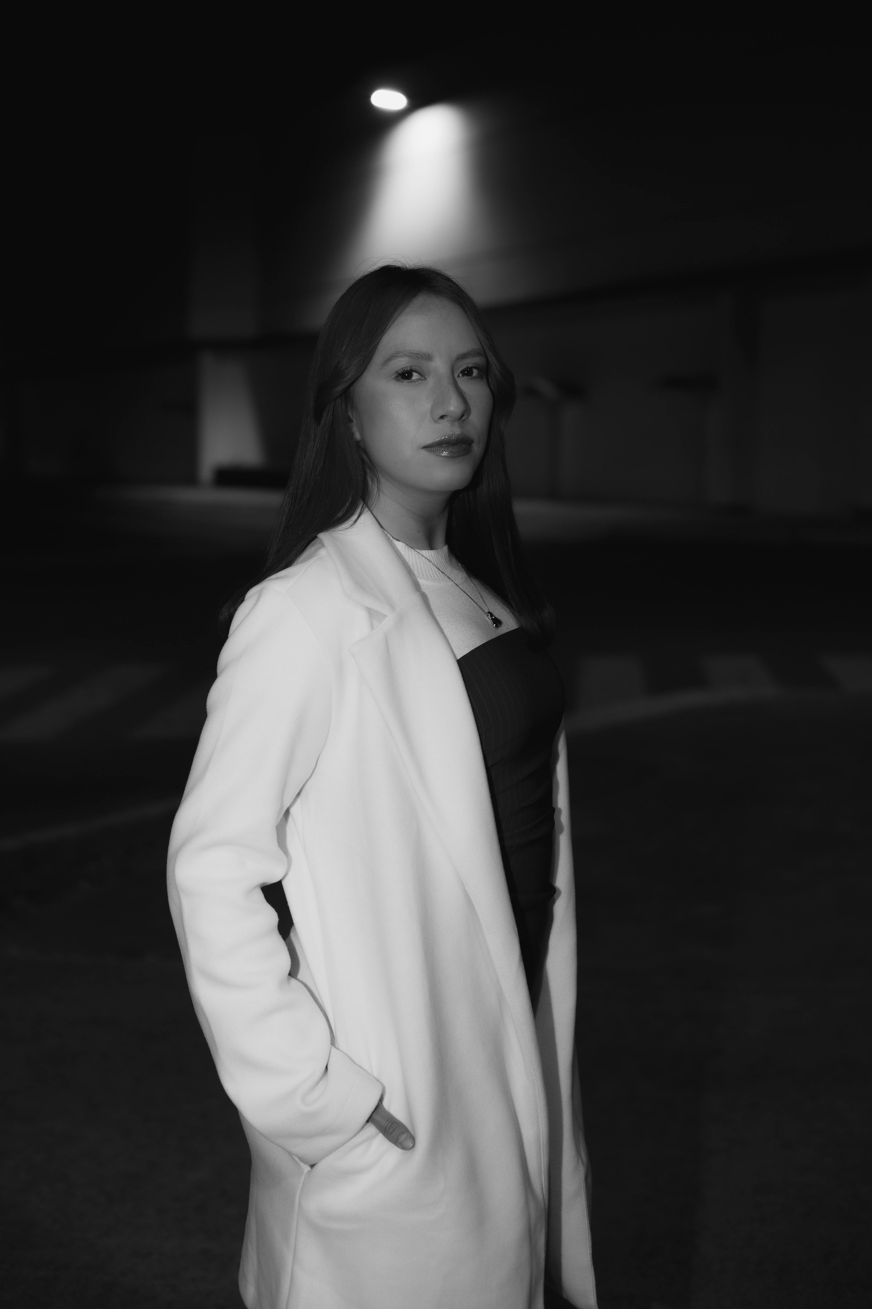 Free Elegant black and white portrait of a woman in a city at night. Stock Photo