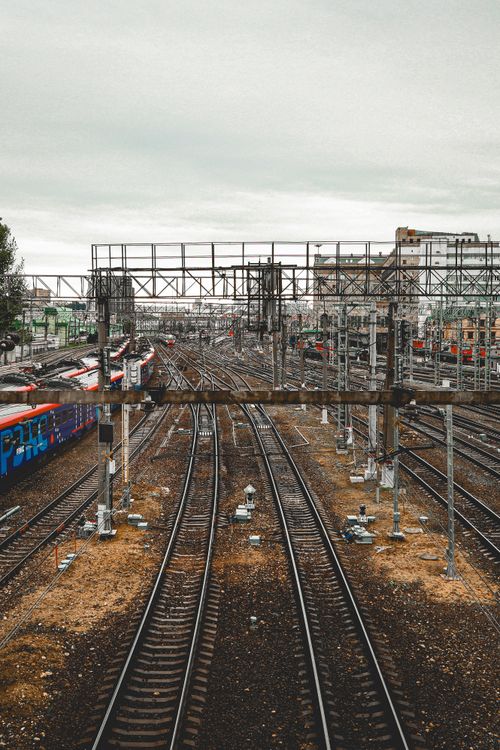 Free Expansive view of railway tracks in Moscow with urban buildings and cloudy sky. Stock Photo