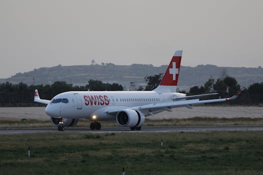 Swiss airplane preparing for takeoff during twilight on a runway.