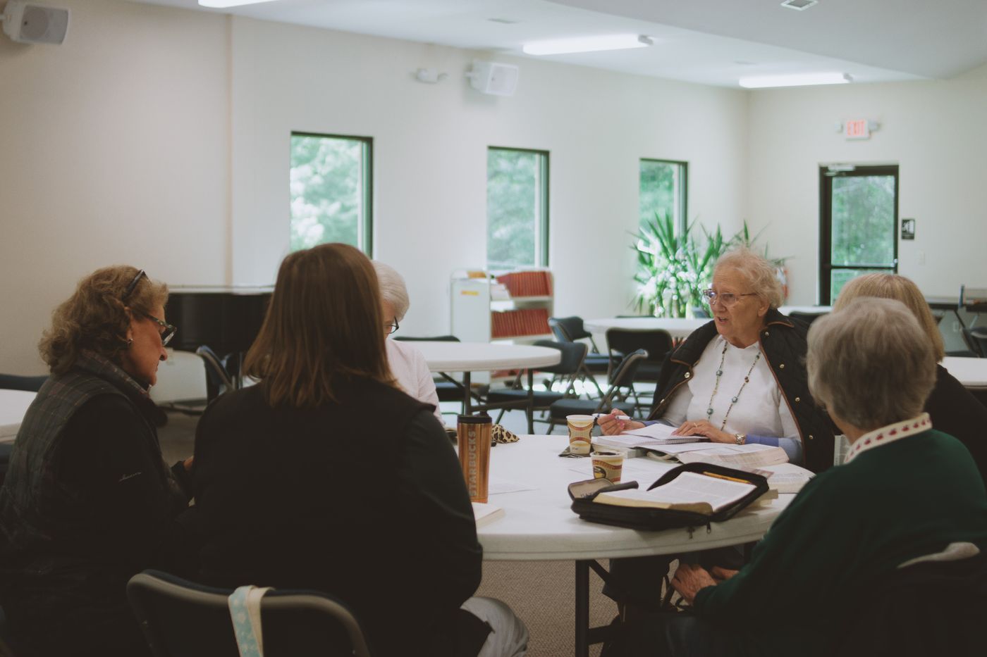 People gathered around a table for Bible study