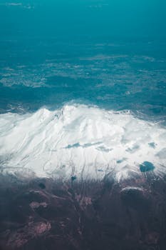 A breathtaking aerial image of the snow-covered peaks of Erciyes Mountain in Turkey, showcasing its majestic beauty.