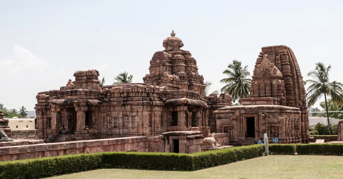 A South Indian temple with traditional gopuram architecture against a clear sky