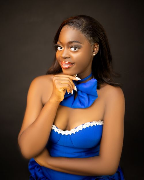 Free Charming woman in blue dress posing with confidence and elegance. Stock Photo