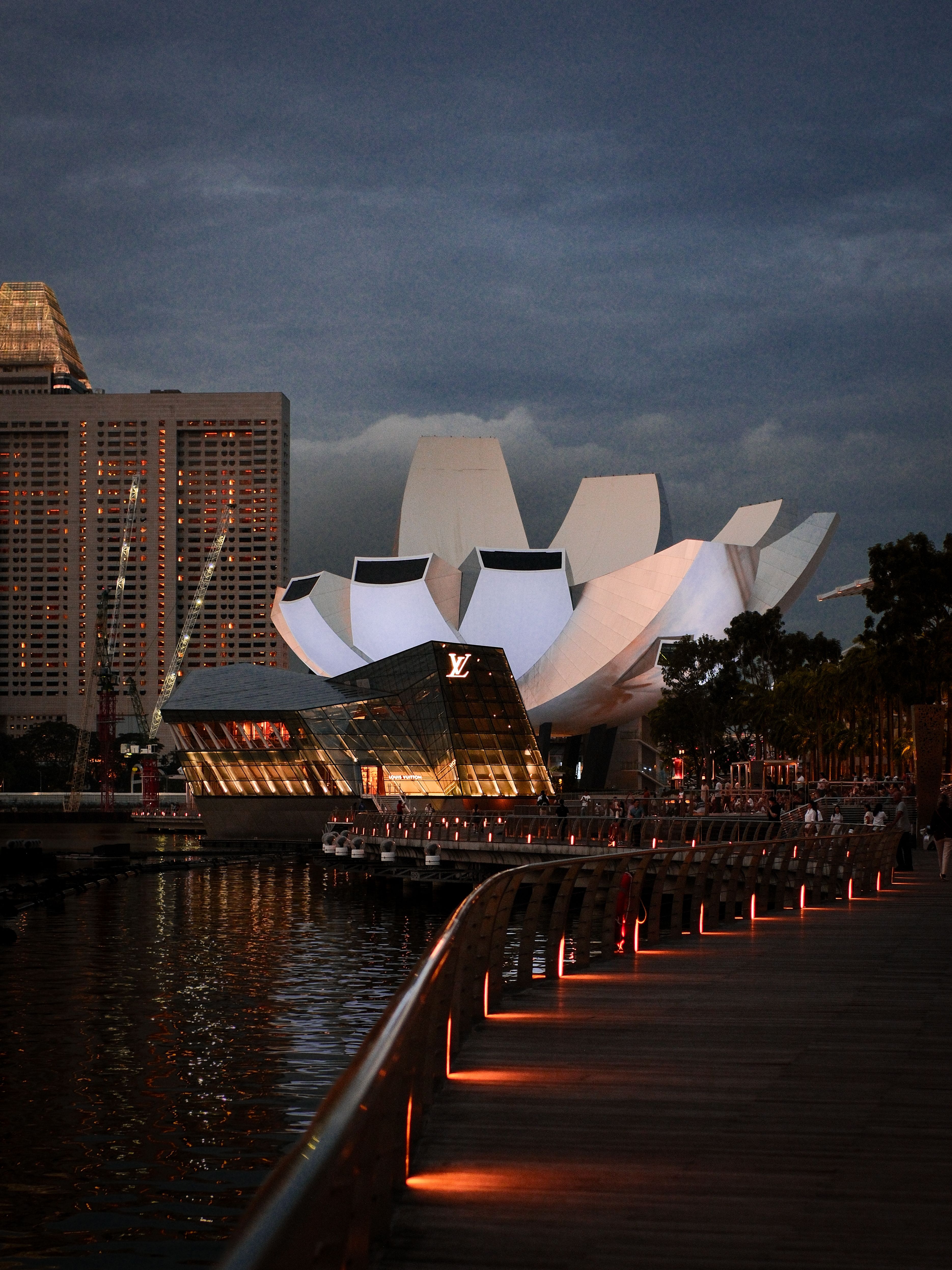 Illuminated Marina Bay waterfront at dusk in Singapore.