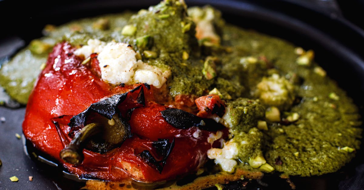 Close-up of a traditional Mexican stuffed chili pepper topped with green sauce, served in Mexico City.