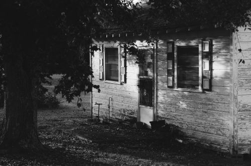 Free Vintage black and white shot of a weathered house exterior with rustic charm. Stock Photo