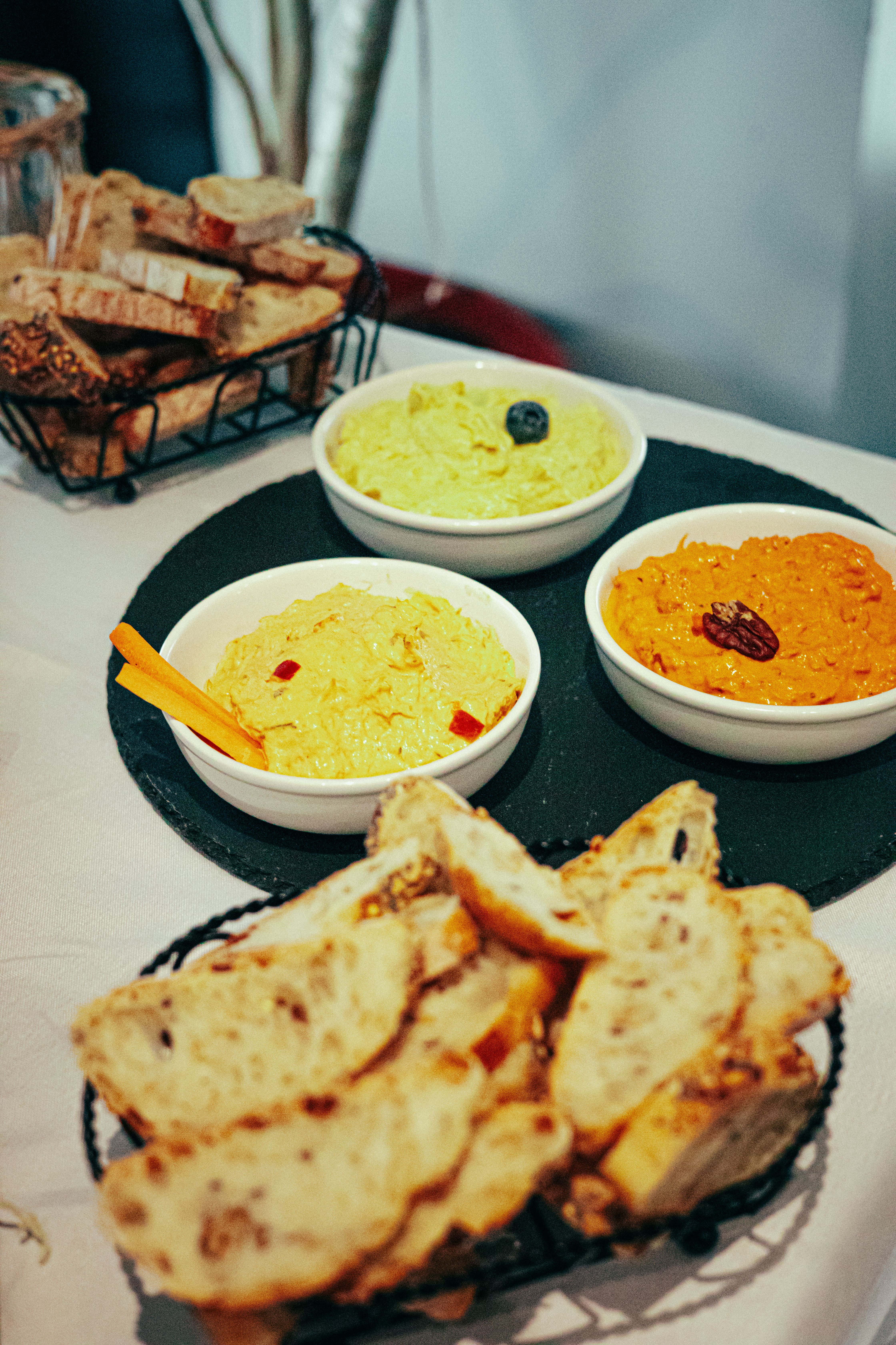 Delicious Trio of Colorful Dips with Bread · Free Stock Photo