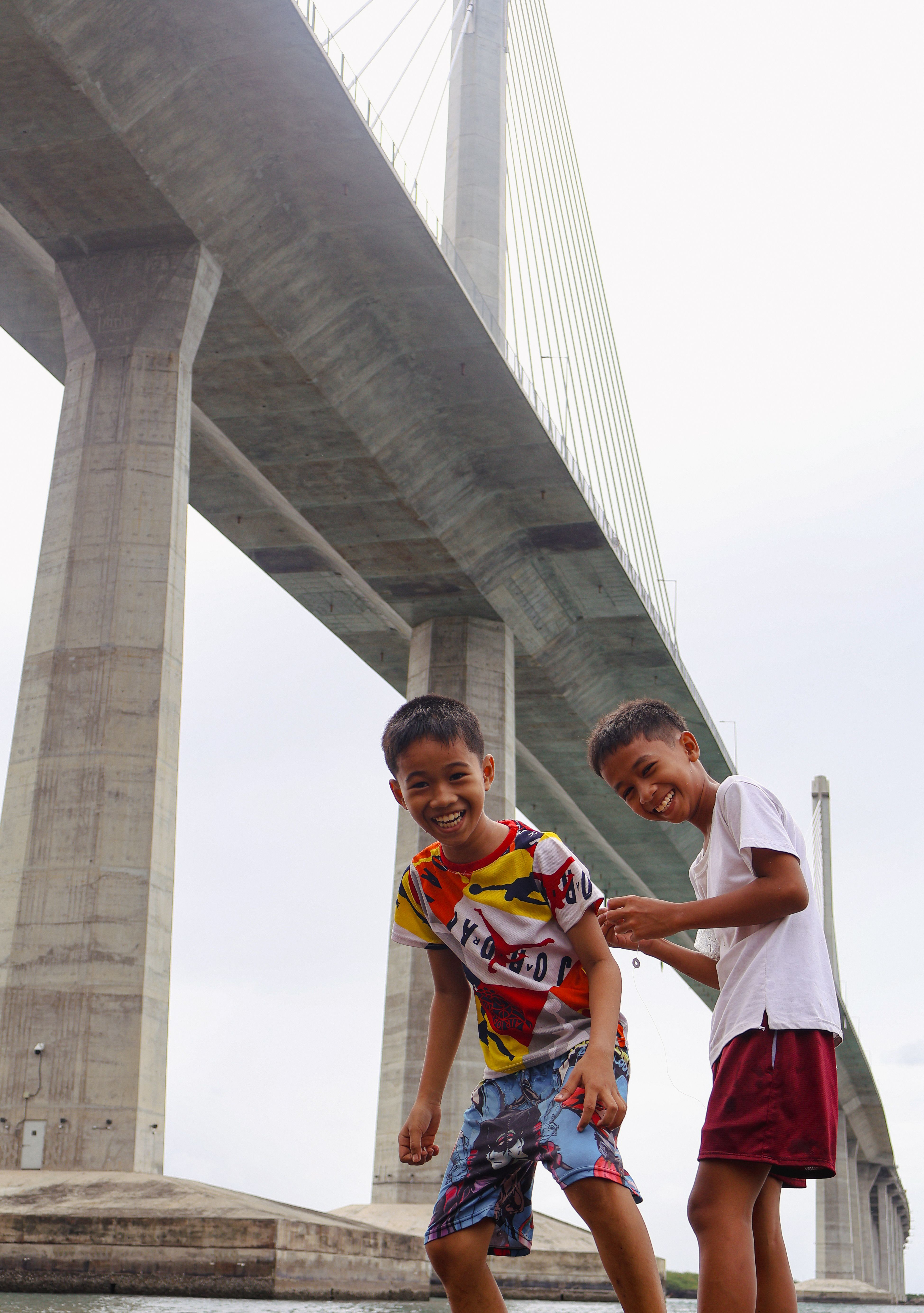 Happy Children Playing Under a Majestic Bridge · Free Stock Photo