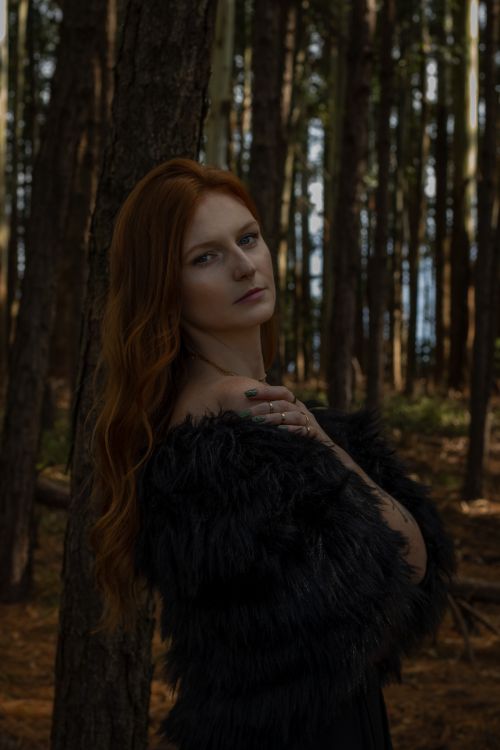 Woman with Red Hair Smiling in Forest Setting · Free Stock Photo