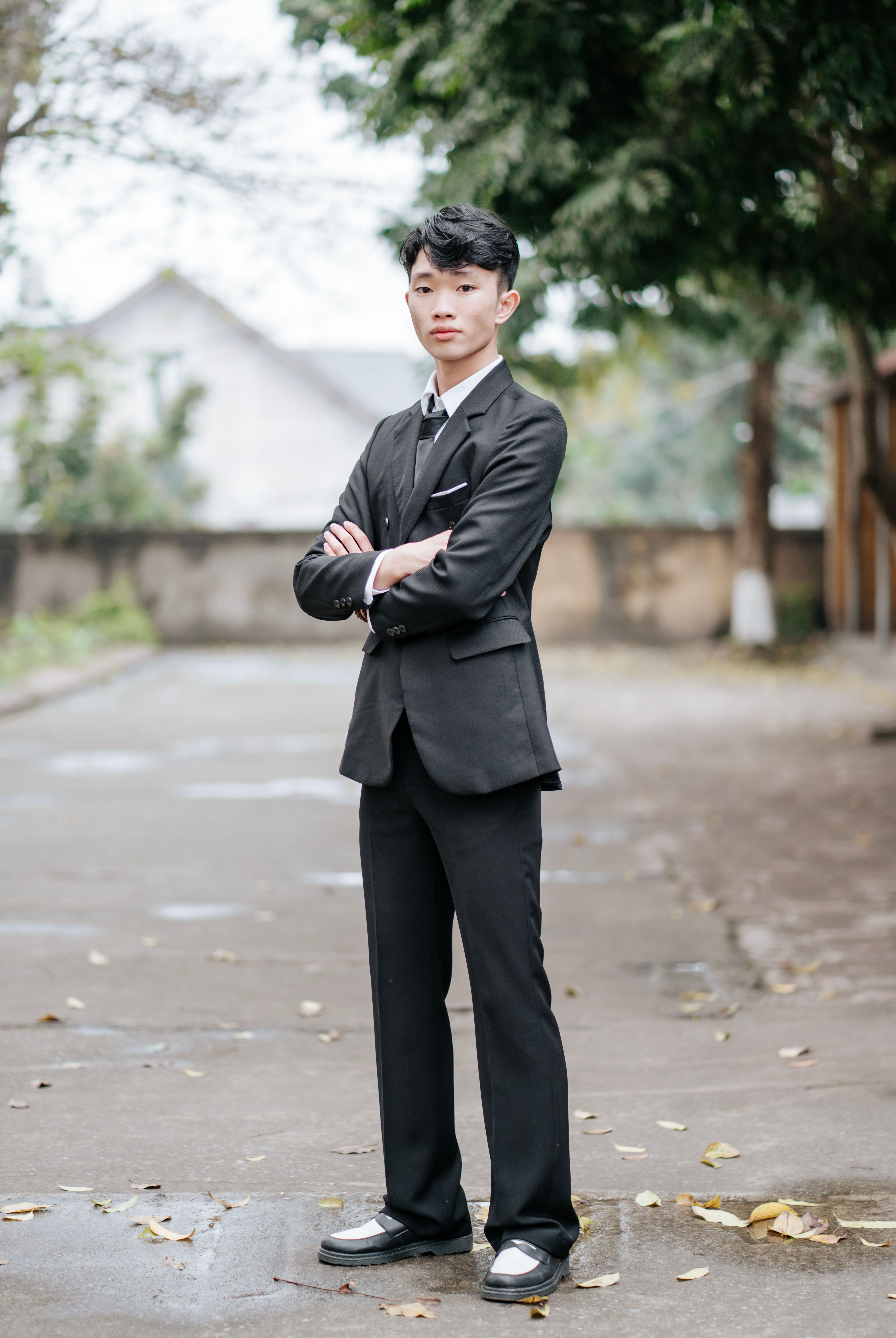 Young Man in Formal Suit on Outdoor Path · Free Stock Photo