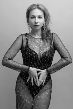 Portrait of a woman in a sparkling dress, showcasing elegance in black and white.