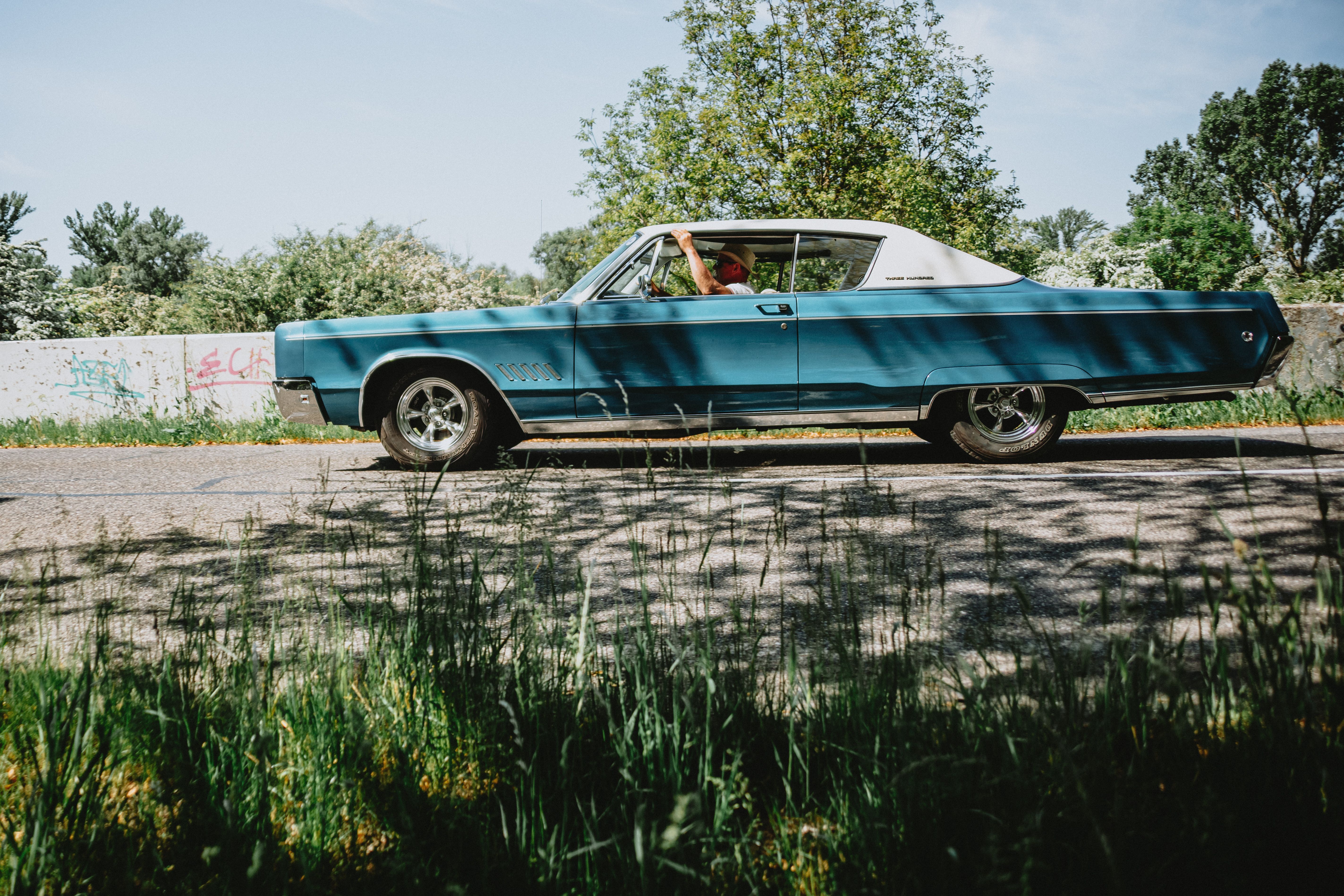 Vintage Blue Car on Sunny Rural Road · Free Stock Photo