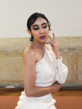 Elegant portrait of a woman in stylish attire, captured in an indoor setting, exuding fashion and grace.