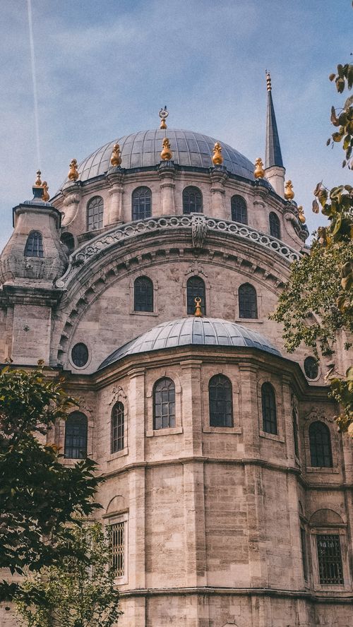 Free Explore the grandeur of Ottoman architecture with this detailed domed building captured under a clear sky. Stock Photo