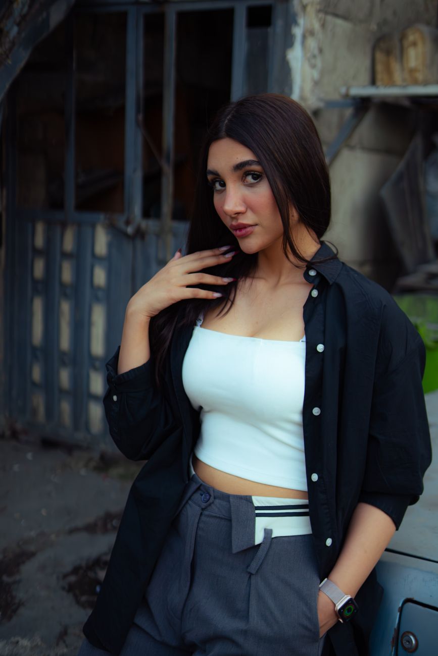 Fashionable young woman posing in Tehran, showcasing modern street style in a casual setting.