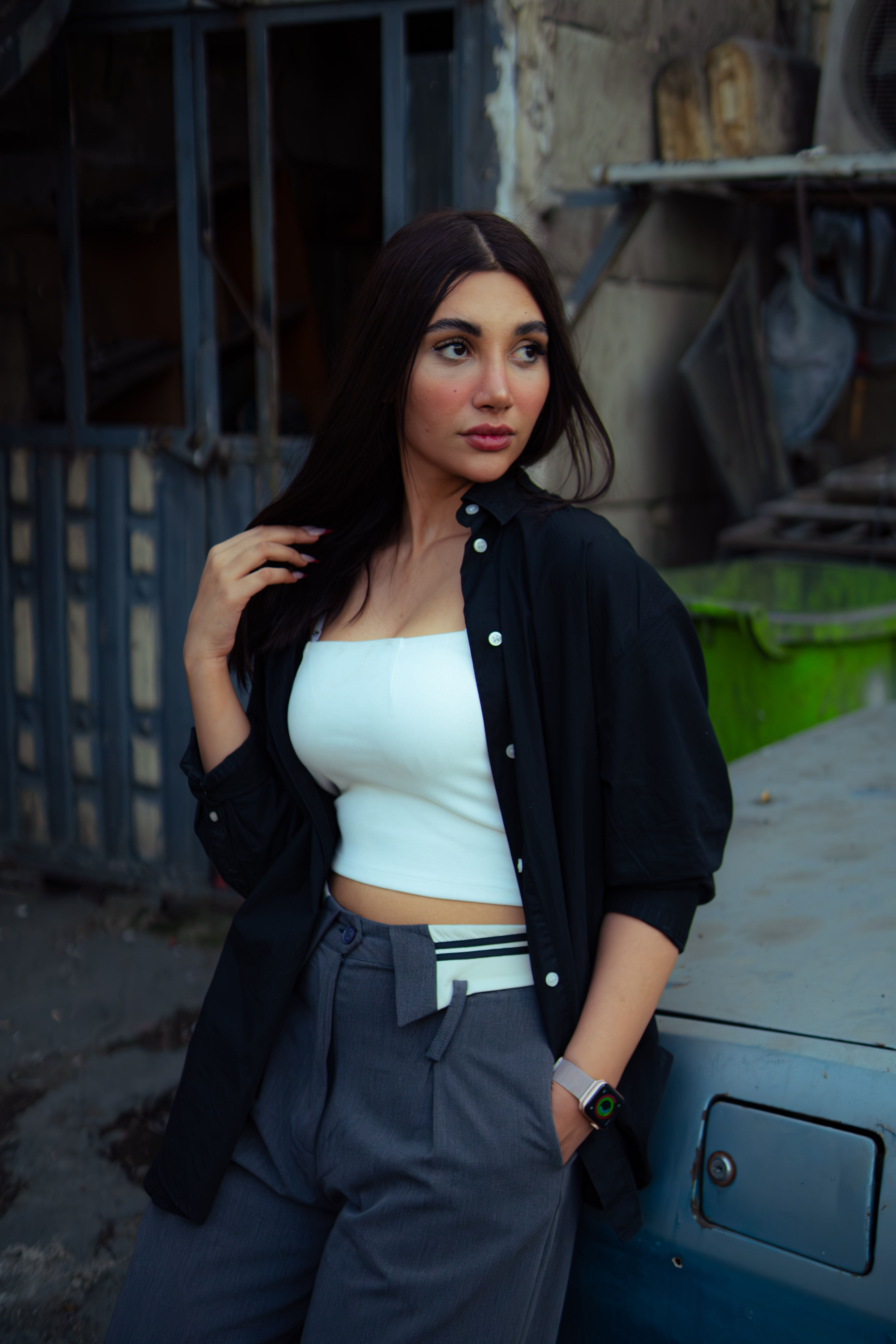 Stylish woman with long hair poses confidently outside in Tehran, showcasing modern fashion.