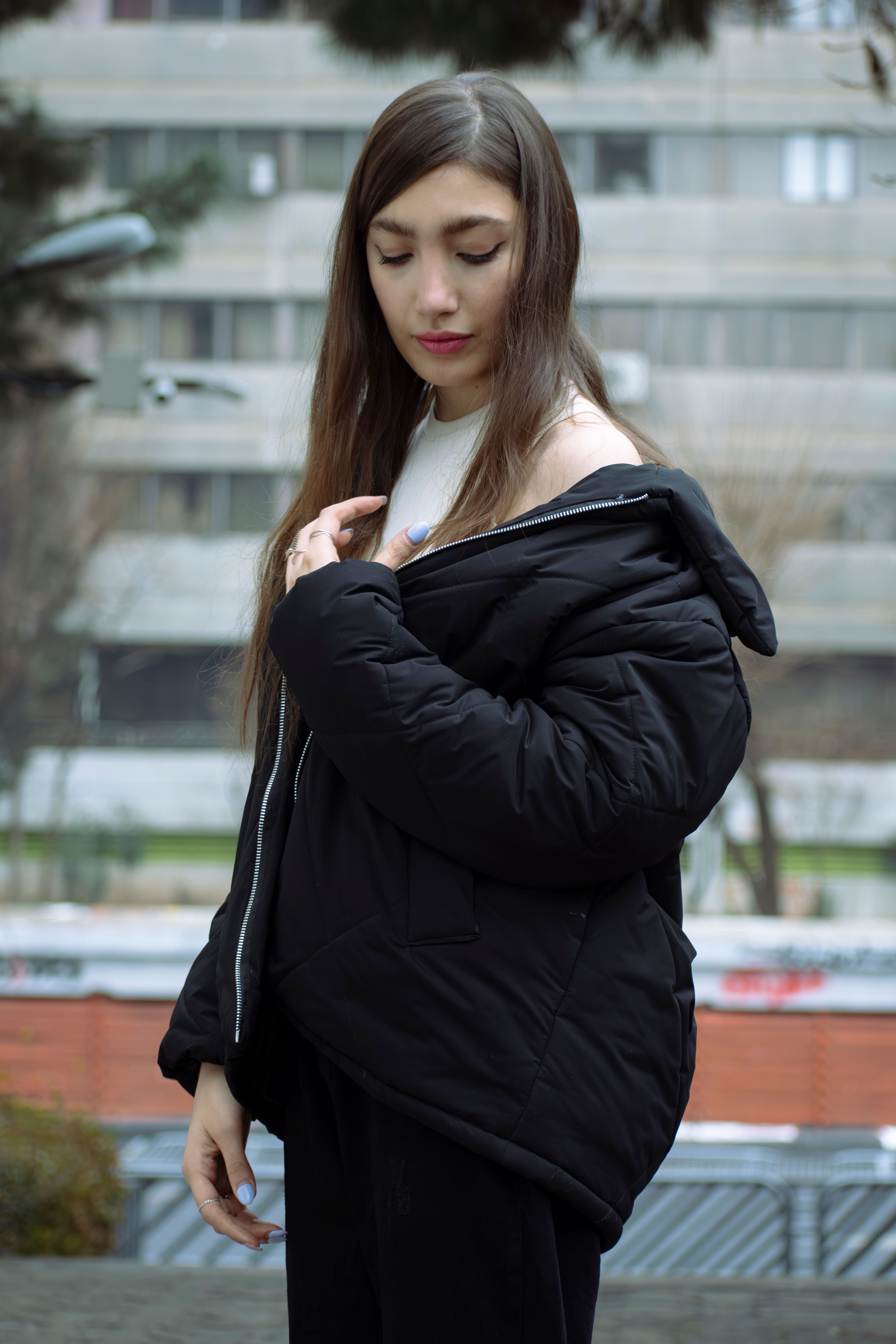 Young Woman in Black Jacket on City Street · Free Stock Photo