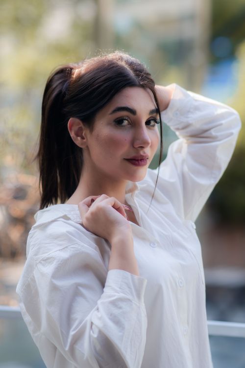 Free Elegant portrait of a woman in a white shirt outdoors in Tehran, Iran. Stock Photo